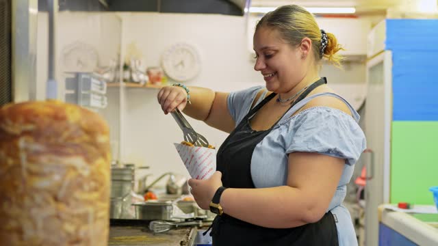 Female Food Service Worker Preparing Gyros At A Diner