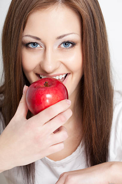 istock woman going to eat red apple 177803140