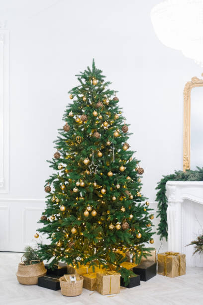 istock A large beautiful Christmas tree decorated with beautiful shiny trinkets and lots of different gifts on the floor. 1778034110