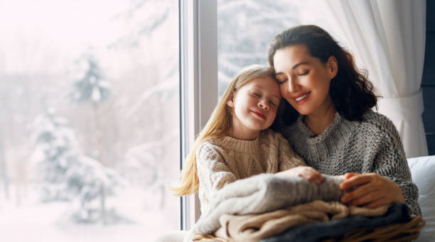 Winter portrait of family Winter portrait of happy loving family wearing knitted sweaters. Mother and child girl having fun, playing and laughing at home. young hot stock pictures, royalty-free photos & images