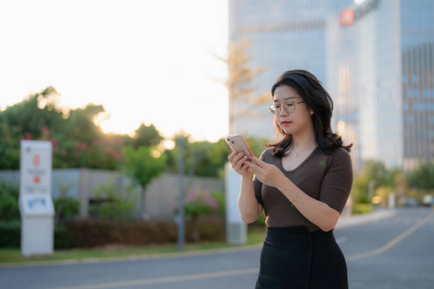 istock Asian business lady using smartphone 1778042101