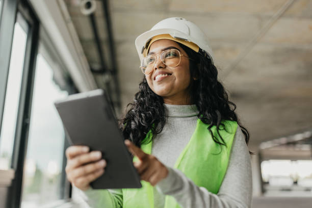 I need to record this Beautifull Indian female inspector wearing protective equipment using tablet asian female engineer stock pictures, royalty-free photos & images