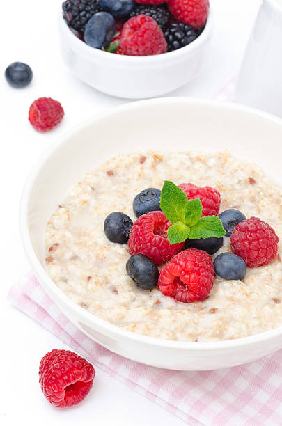 istock healthy breakfast - oatmeal with fresh berries isolated on white 177804502