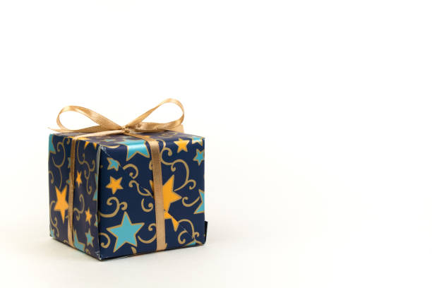 Blue gift ribbon and bow on gold paper background. High quality photo