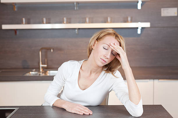 mujer en cocina - angestrengt fotografías e imágenes de stock