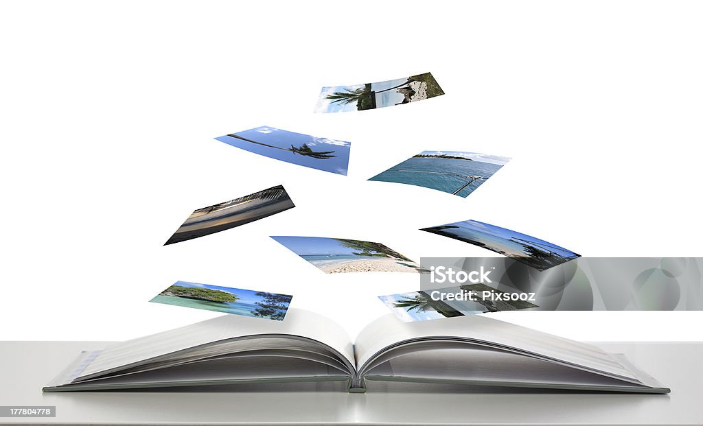 Photobook with Photos of Beach Scenes Floating Photobook concept with photos floating down onto book Photographic Print Stock Photo