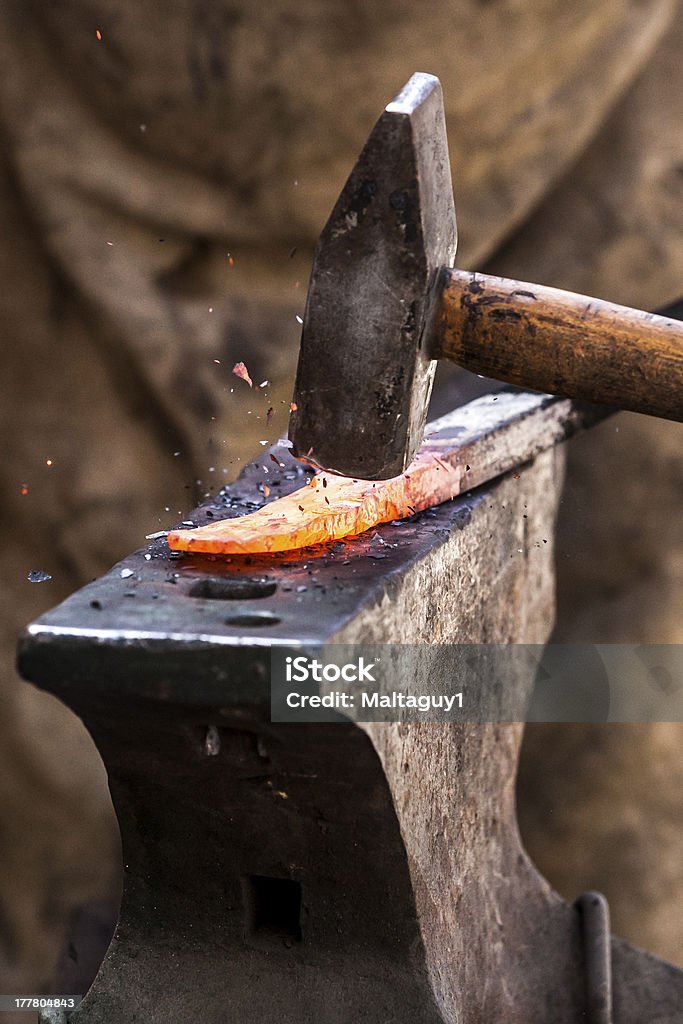 Metal Works Blacksmith working on metal on anvil at forge detail shot Blacksmith Stock Photo