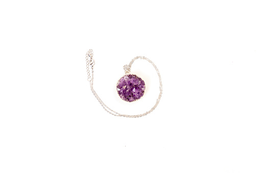 Amethyst directly above over white background, a violet variety of quartz, often used in jewelry. Silica, silicon dioxide, SiO2.