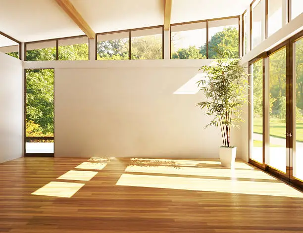Photo of Empty modern room with sun-filled windows