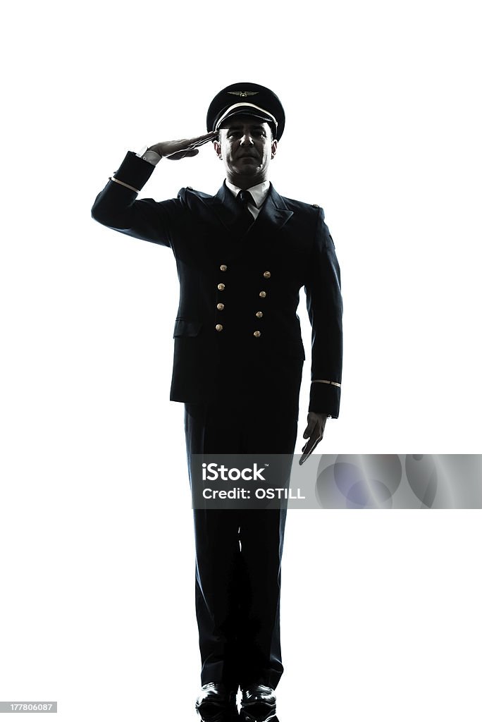 man in airline pilot uniform silhouette saluting one caucasian man in airline pilot uniform saluting silhouette  in studio on white background Military Stock Photo