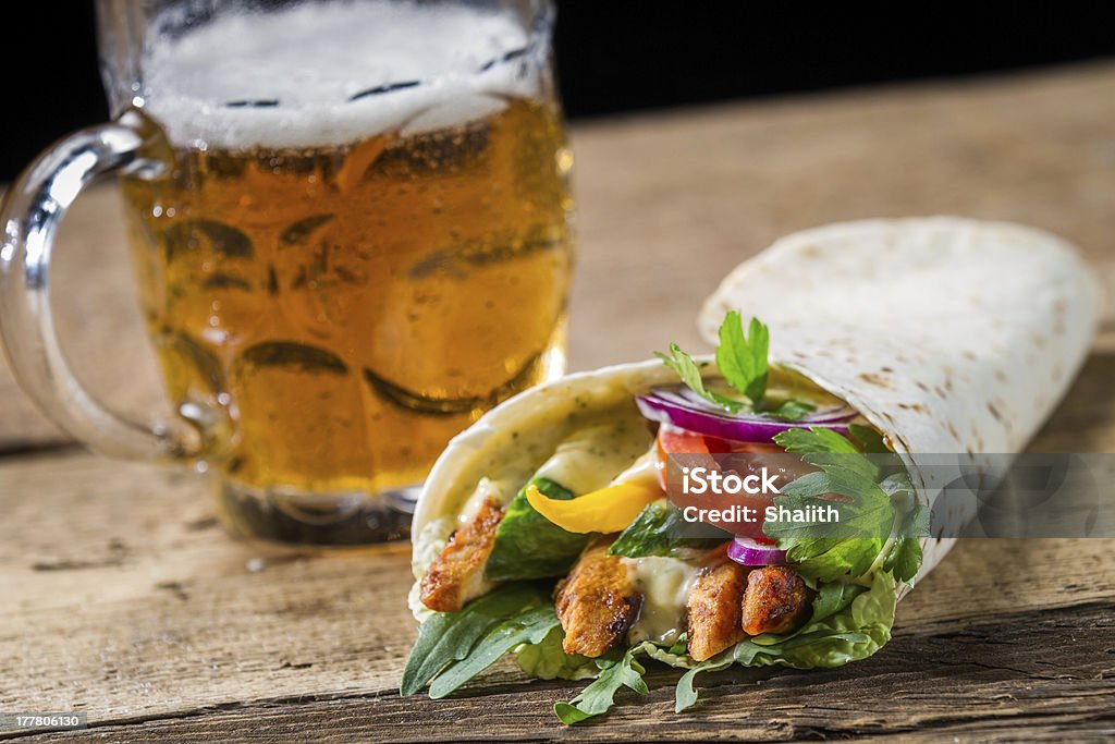 Kebab served with cold beer on old wooden table Kebab served with cold beer on old wooden table. Alcohol - Drink Stock Photo