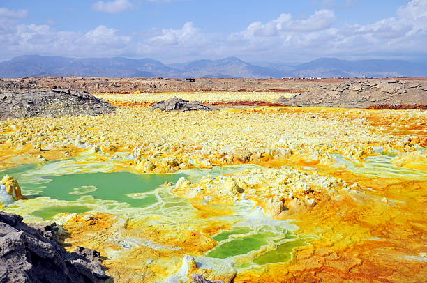 The explosion crater of Dallol volcano, Danakil Depression, Ethiopia The volcanic explosion crater of Dallol in the Danakil Depresseion in Nothern Ethiopia. The Dallol crater was formed during a phreatic eruption in 1926. This crater is known as the lowest subaerial vulcanic vents in the world. The surreal colours are caused by green acid ponds and iron oxides and sulfur. dallol ethiopia stock pictures, royalty-free photos & images