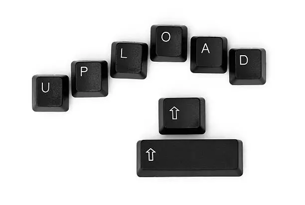 UPLOAD word written on a keyboard. Isolated on a white background.