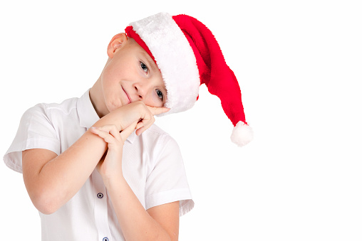 Adorable child with red hat of Christmas on a over white background he is cute and thoughtful