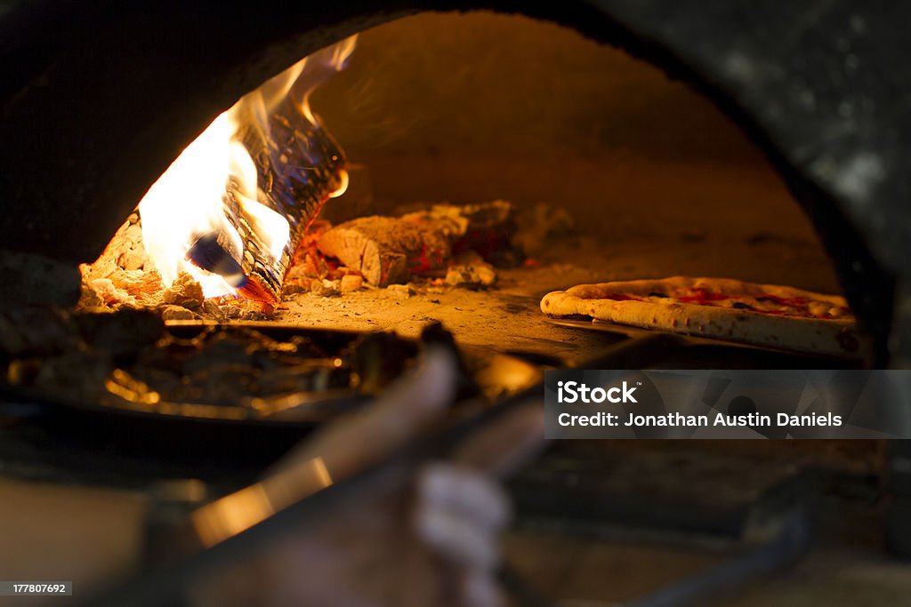 Wood Oven Pizza Pizza baking in wood oven. Pizza Oven Stock Photo