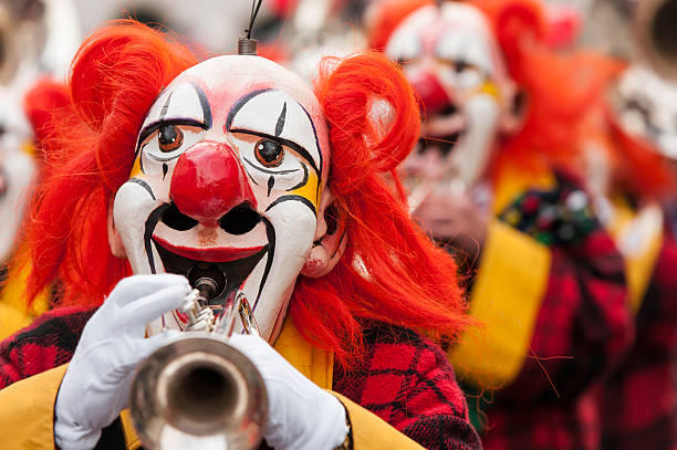 Carnival Clowns Playing Trumpet Colorful clown group playing the trumpet at Basel fasnacht festival. caricature photos stock pictures, royalty-free photos & images