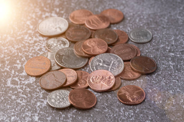 American coins and US dollars on a wooden table