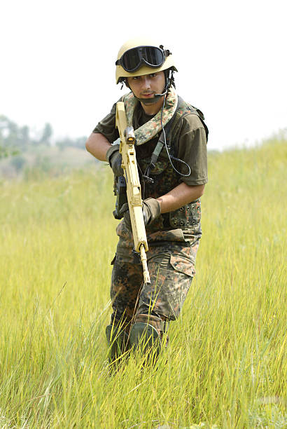 istock Young soldier in helmet with a gun 177809335