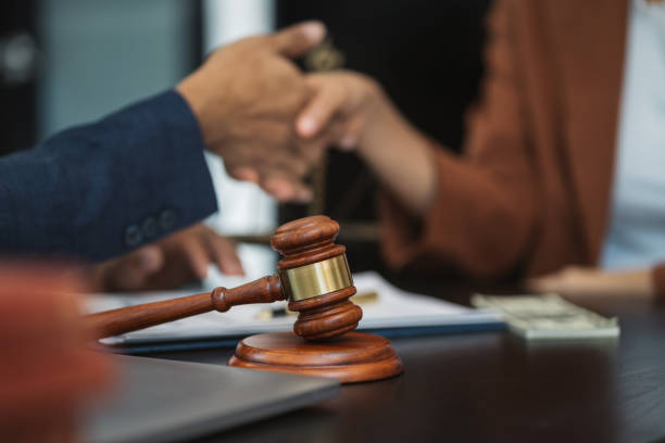 istock Lawyer shaking hands with client after discussing final contract agreement. 1778093530