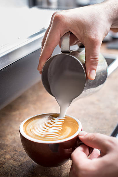 istock Hands Pouring Froth Art into a Cappucinno 177809405