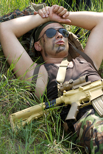 istock Soldier takes rest lying on a grass 177809514