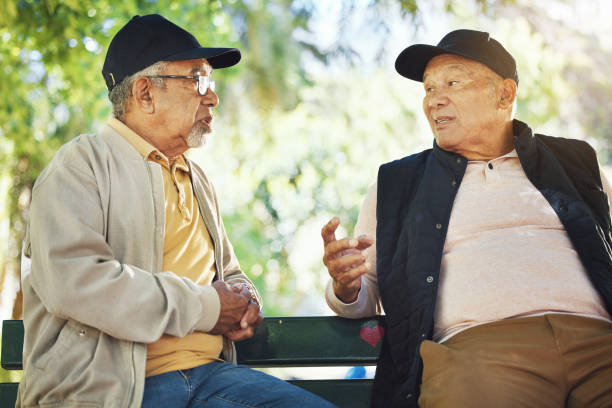 istock Elderly men, park and communication with friendship, nature and conversation with bonding on bench. Diversity, closeup and old people with community for socialize, relaxation and discussion on life 1778095785