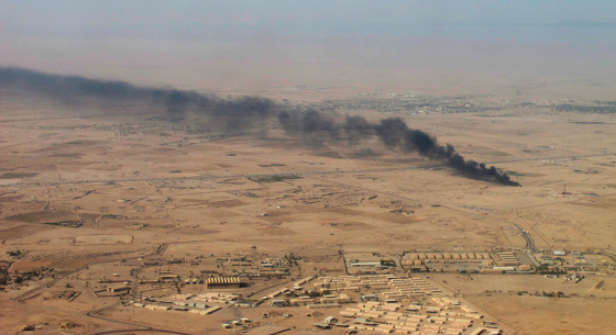 On the horizon, a huge cloud of dense smoke from the burning oil well stretched across the sky. Iraq.