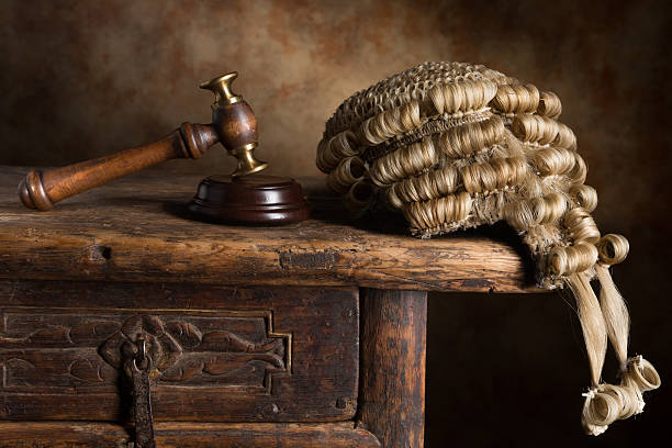 Traditional looking judge with white wig and gavel.