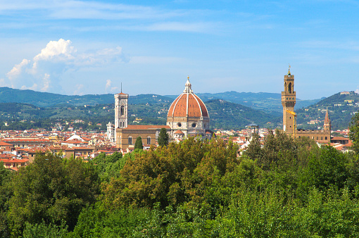 Florence, Tuscany, Italy - May 24, 2017: Cathedral of Santa Maria del Fiore known as the Duomo and the Arnolfo Tower (Torre di Arnolfo) on a beautiful day
