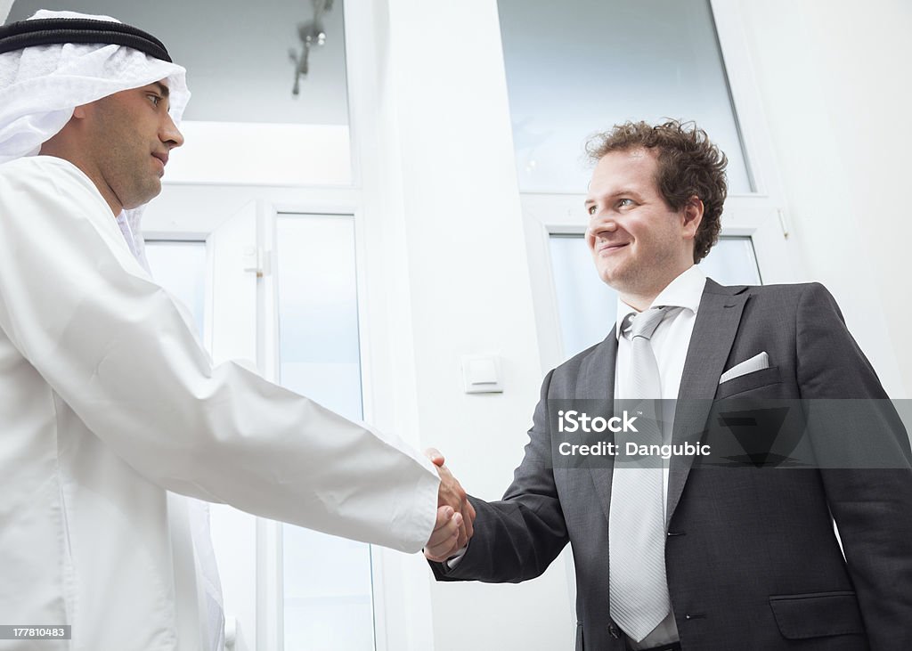 Businesspeople shaking hands Businessmen congratulating each other's business success. Achievement Stock Photo