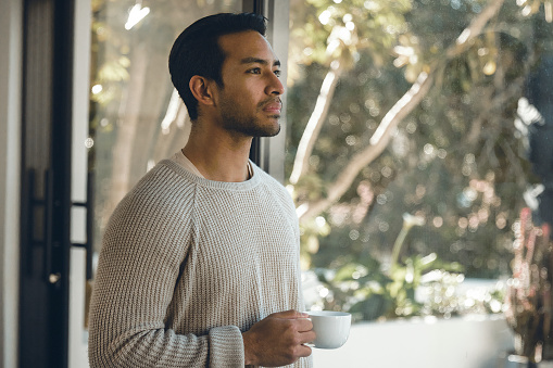 Embark on a journey of morning contemplation as a man sips his coffee, gazing through the window, lost in thought. The subtle dance of steam and the quietude of his gaze paint a serene tableau, inviting you to share in the tranquil moments of introspection that dawn brings.