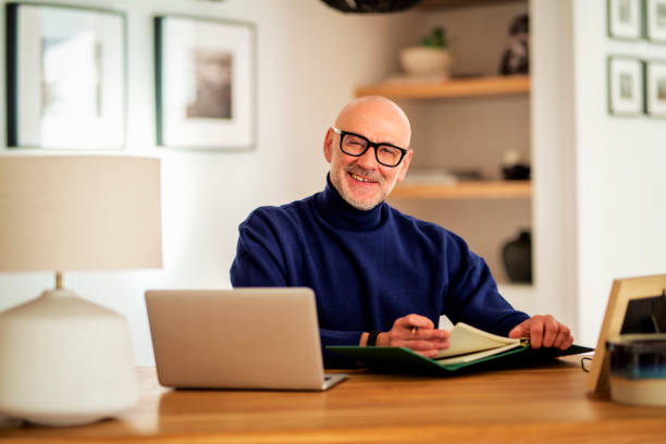 istock Confident mid aged businessman sitting at home and using laptop for work 1778107626