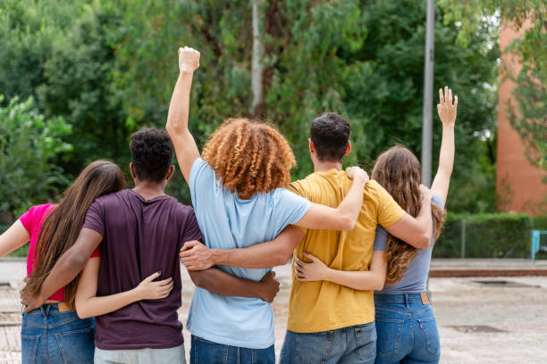istock back view of multicultural friends standing in circle with raised hands and looking at each other 1778111481