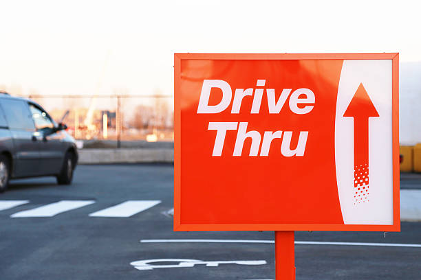 Red and white Drive Thru street sign A classic drive thru sign. drive through photos stock pictures, royalty-free photos & images