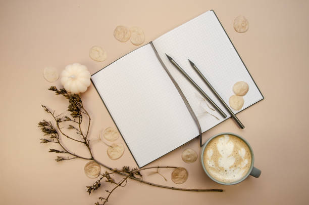 istock Notepad copyspace, gray pencils and cup of coffee on tan beige background with dry brown branches. Autumn minimal flatlay 1778119453