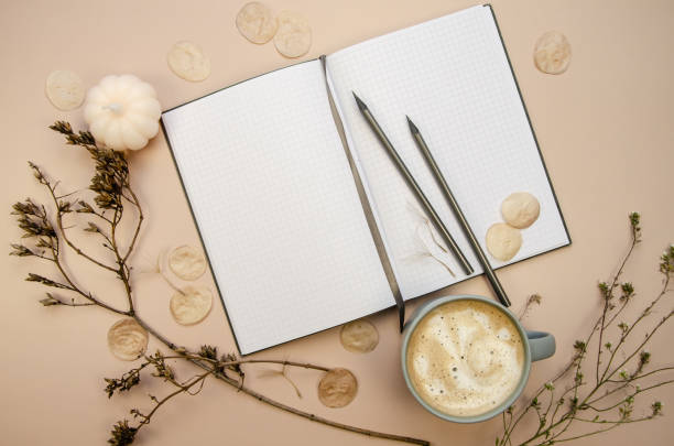 istock Notepad copyspace, gray pencils and cup of coffee on tan beige background with dry brown branches. Autumn minimal flatlay 1778119455