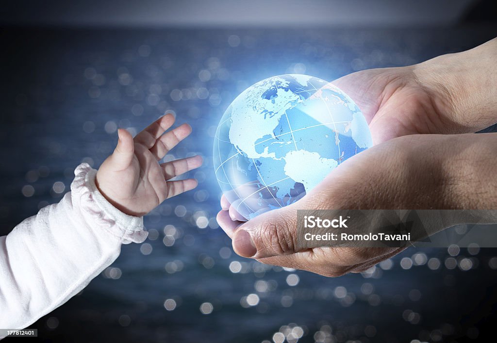 new generation baby and old hands with globe  - sea background Globe - Navigational Equipment Stock Photo