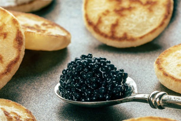 istock Silver spoon with caviar closeup with blinis, an elegant festive appetizer 1778128997