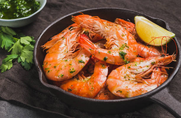 istock Shrimps stir-fried in pan on dark background. 1778135286
