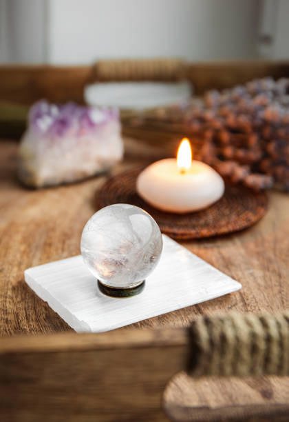 istock Gemstone sphere or crystal balls known as crystallum orbis and orbuculum which is the beacon of peace and harmony in home environment. Natural clear quartz ball on stand on wood tray in home. 1778140584