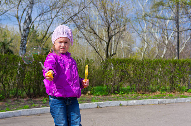 istock Little girl with soap bubbles 177814227