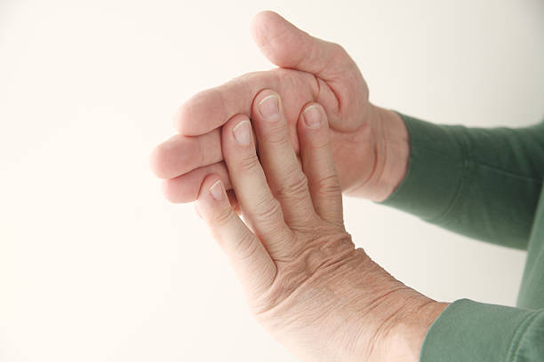 istock man flexing fingers against hand 177814423
