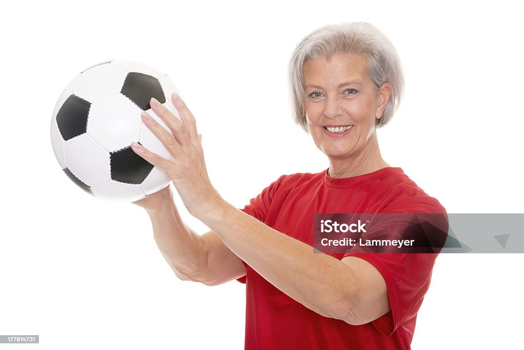 Soccer time Senior woman with football Active Lifestyle Stock Photo