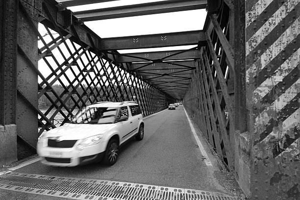 Steel bridge and a white car
