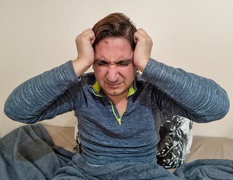 Man suffering from headache or migraine