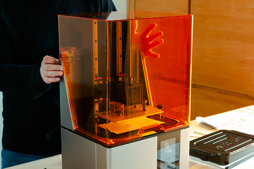 Man preparing a 3d resin printer before use