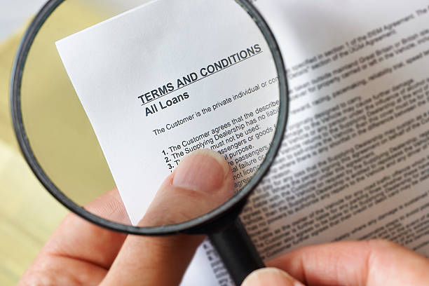 Magnifying glass hands holding magnifying glass reading terms and conditions of loan agreement read the fine print stock pictures, royalty-free photos & images