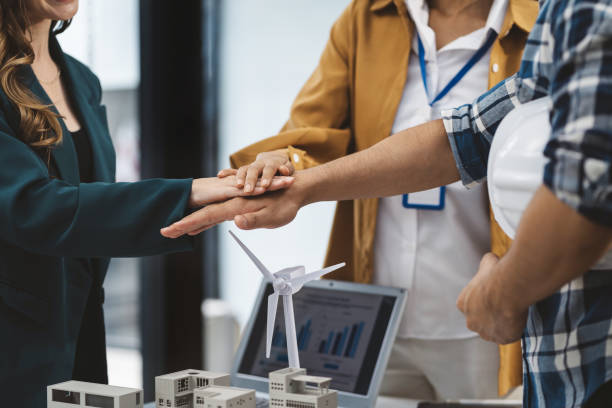 istock Team architects workers, men and women, join hands to join forces to join forces to work for the industry for success. 1778172733