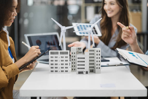 istock Businessman and designer working making model apartments. with blueprints for sketching a construction project, green energy and solar panel concept. 1778172775