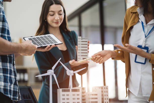 istock Businessman and designer working making model apartments. with blueprints for sketching a construction project, green energy and solar panel concept. 1778172785